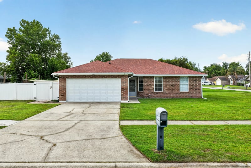 Front exterior with red tile roof and driveway at 2164 Orangewood St, Middleburg, FL 32068