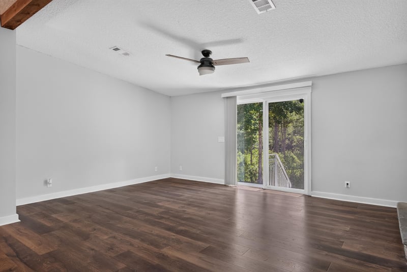 Living room with ceiling fan and sliding glass door at 4890 McAllister Rd, Middleburg, FL 32068