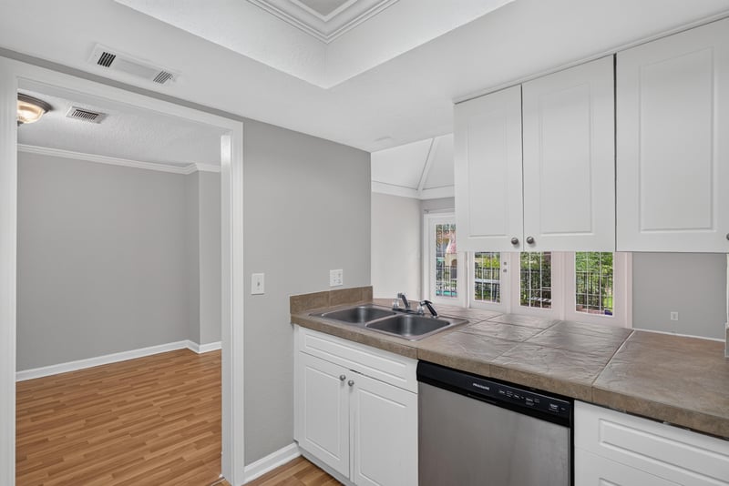Kitchen with tray ceiling and white cabinets at 3866 Campenero Ct unit 6, Jacksonville, FL 32217