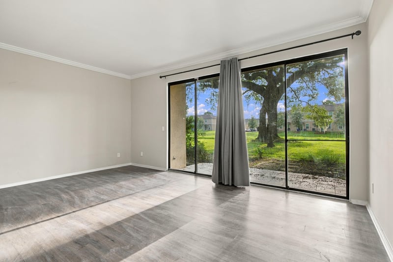 Living room with sliding glass doors and wood-look floor at 7703 Las Palmas Way
