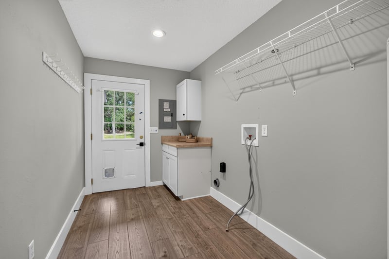Laundry room with shelving and door at 1161 Whispering Pines Rd, Jacksonville, FL 32259