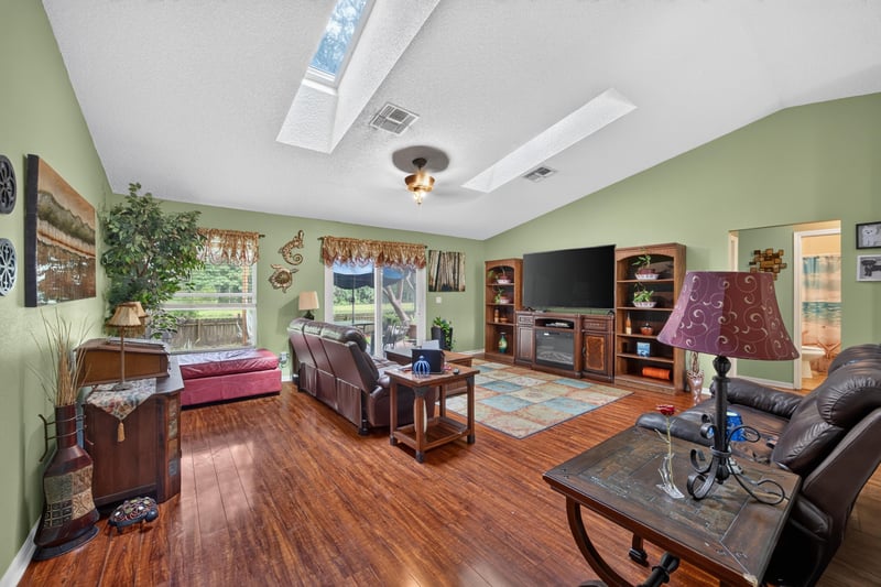 Family room with vaulted ceiling and skylights at 145 Dover Bluff Dr, Orange Park, FL