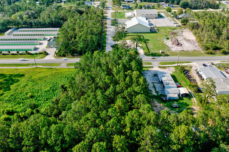 Aerial of storage buildings and the intersection along Co Rd 218 at 4393 Co Rd 218, Middleburg, FL 32068
