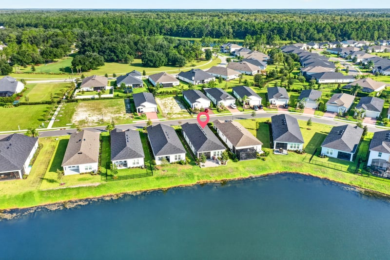 Aerial view of the home's street and pond in St. Augustine, FL