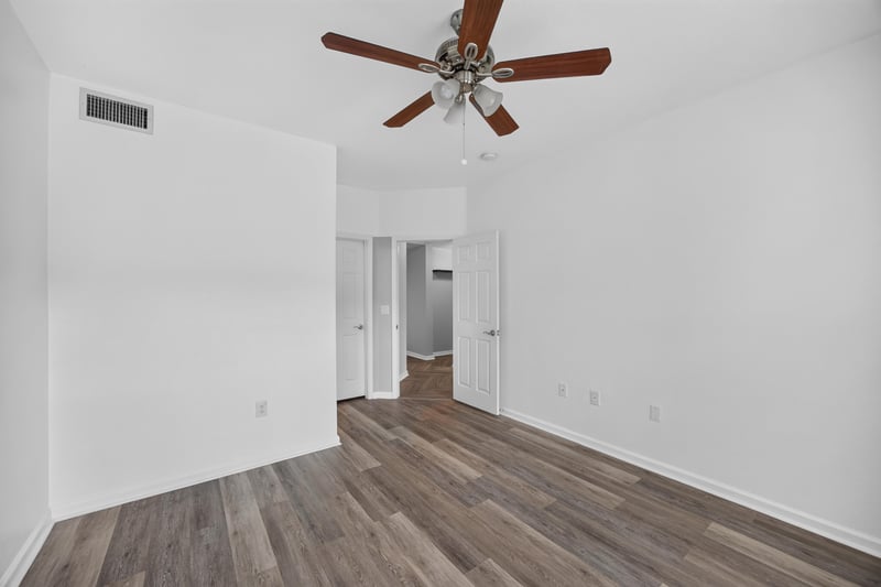 Empty room with ceiling fan and hallway view at 10075 Gate Pkwy unit 1905, Jacksonville, FL 32246