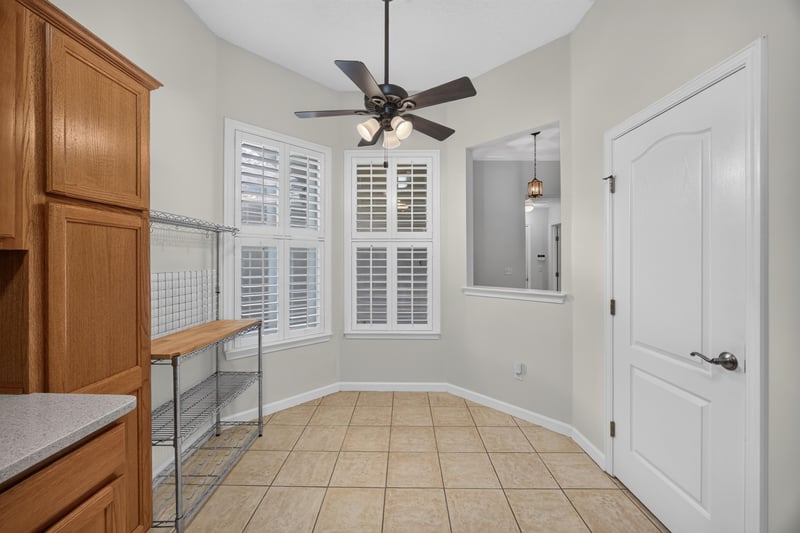 Hallway with tile floor and plantation shutters at 2131 E Stone Creek Dr, Fleming Island, FL