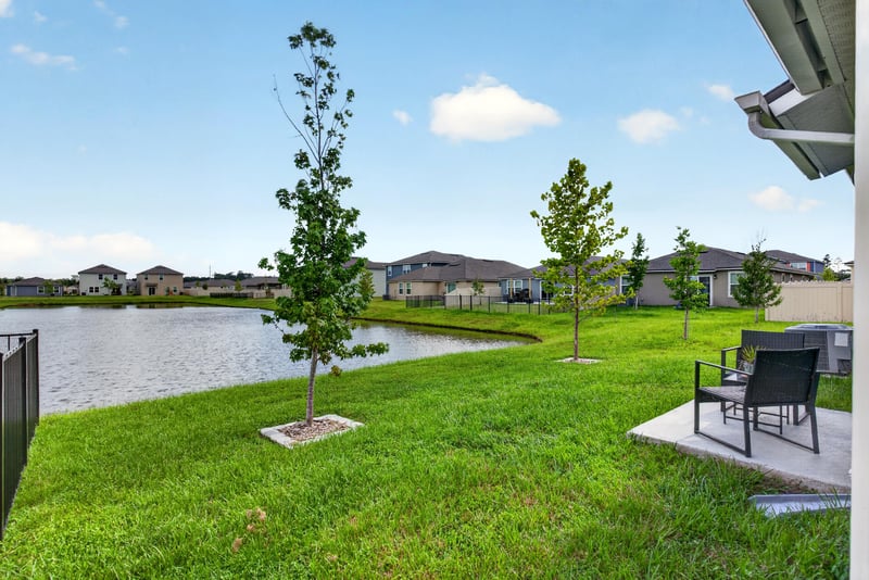 Pond and open lawn with young trees in Jacksonville, FL