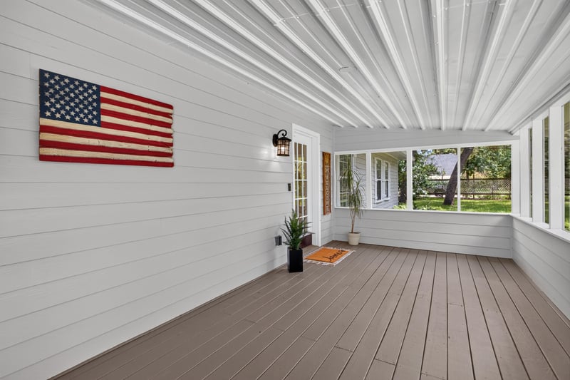 Screened porch with American flag on wall at 1161 Whispering Pines Rd, Jacksonville, FL 32259