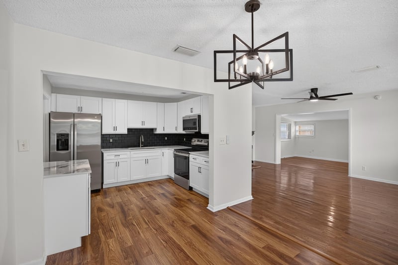 Dining area with pendant light open to kitchen at 4039 Habana Ave, Jacksonville, FL