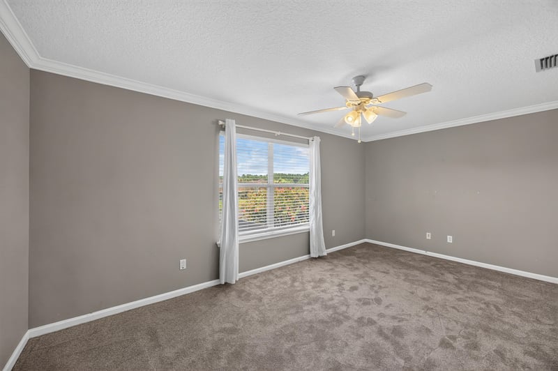 Bedroom with carpet and window at 1493 Greyfield Dr, St. Augustine, FL 32092