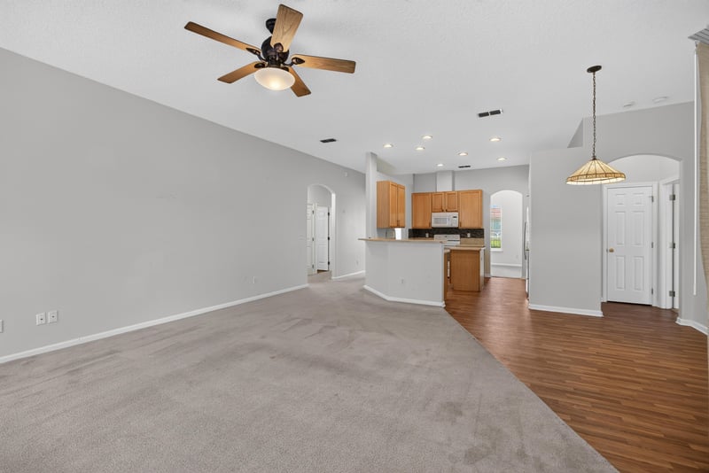 Open living and kitchen area with carpet flooring at 2480 Ridge Will Dr, Jacksonville, FL 32246