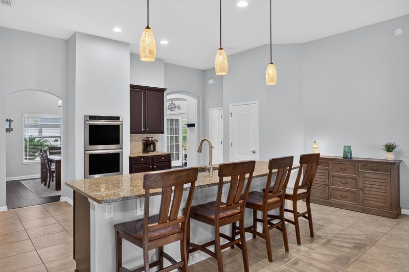 Kitchen island with bar seating and pendant lights at 538 Porta Rosa Circle, St. Augustine, FL 32092