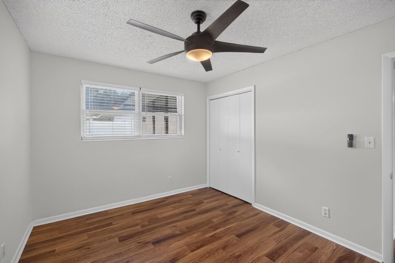 Bedroom with windows, wood floor and ceiling fan at 4039 Habana Ave, Jacksonville, FL