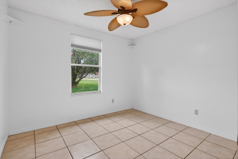 Bedroom with tile floor and ceiling fan at 2164 Orangewood St, Middleburg, FL 32068