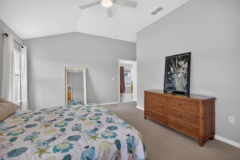 Primary bedroom with bed, dresser, and mirror at 85 Amia Dr, St. Augustine, FL 32086