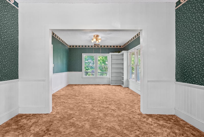 Unfurnished room with green trim and wainscoting at 1173 US-17, Satsuma, FL 32189