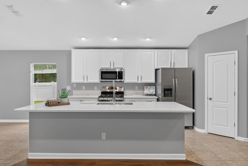 Kitchen with white cabinets and island at 706 Grampian Highlands Dr, St. Johns, FL 32259