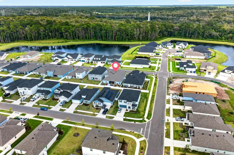 Aerial view of the community pond and rooftops in Middleburg, FL