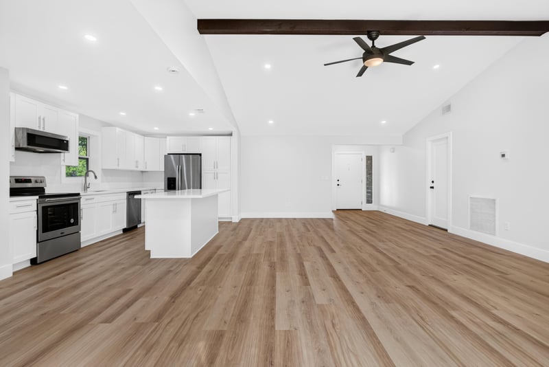 Kitchen island and open layout with wood flooring at 8453 Boysenberry Ln W, Jacksonville, FL