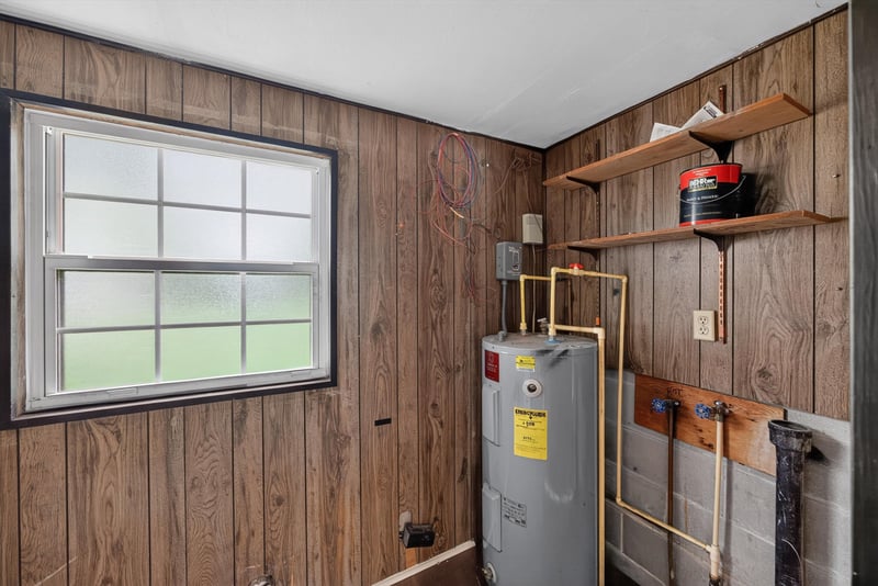 Utility area with water heater and shelving at 5812 Tampico Rd, Jacksonville, FL 32244