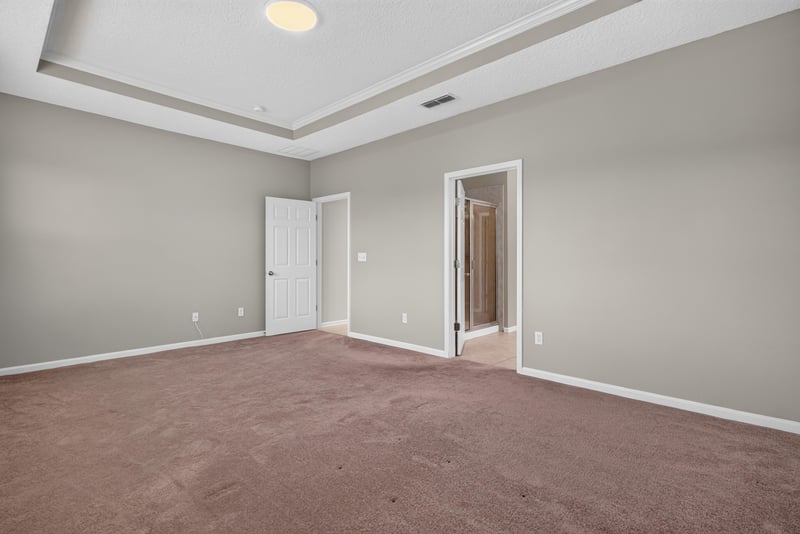 Bedroom with carpet and tray ceiling at 13685 Goodson Pl, Jacksonville, FL 32226