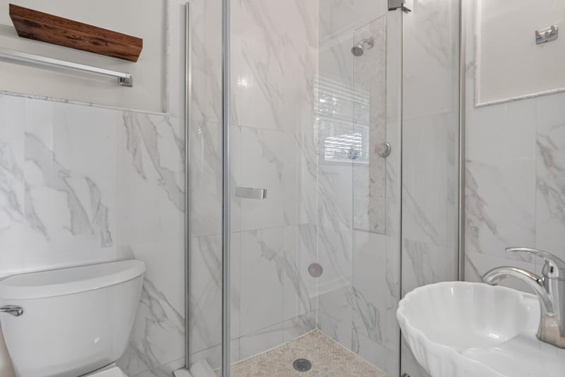 Bathroom with marble-look tile shower at 217 Baisden Rd, Jacksonville, FL 32218