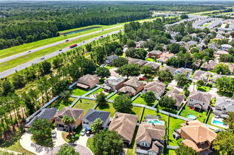 Aerial view of the subdivision and nearby roadway in Orange Park, FL