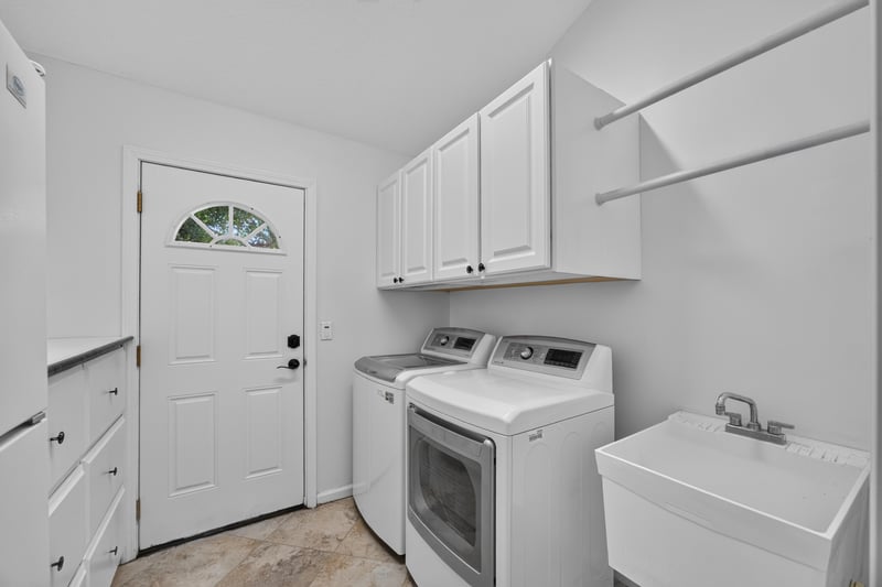 Laundry room with washer, dryer, and utility sink at 11675 Magnolia Estates Rd, Jacksonville, FL 32223