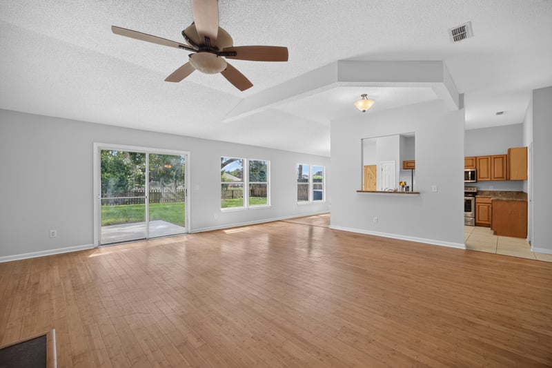 Open living area with sliding glass doors to backyard at 456 Bay Point Way N, Jacksonville, FL 32259