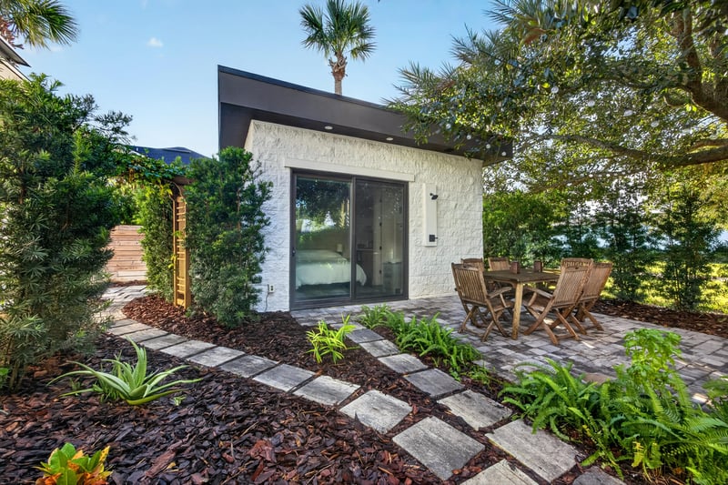 Side yard path leading to covered patio seating area at 722 3rd Ave N, Jacksonville Beach, FL