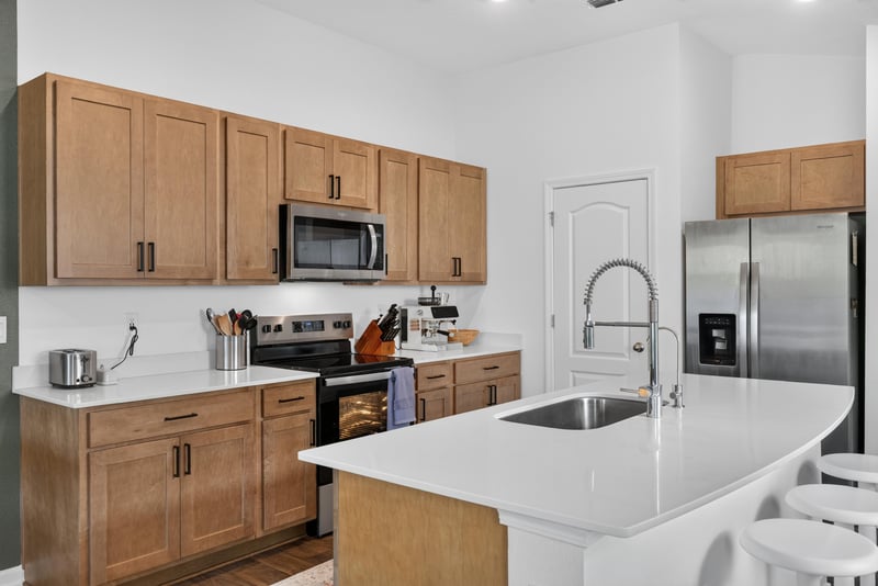 Kitchen sink and wood cabinets at 4276 Quaking St, Jacksonville, FL 32218