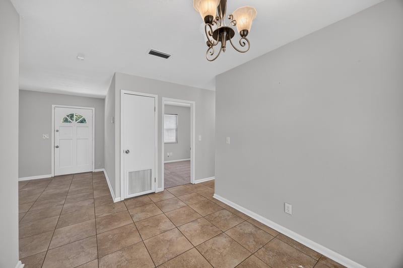 Empty entry hall with tile floor and interior doors at 7453 Jade Dr N, Jacksonville, FL 32210