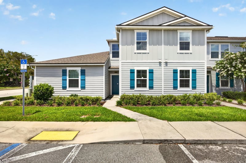Front exterior in daylight with blue shutters at 2837 Black Buck Cir, Jacksonville, FL 32225