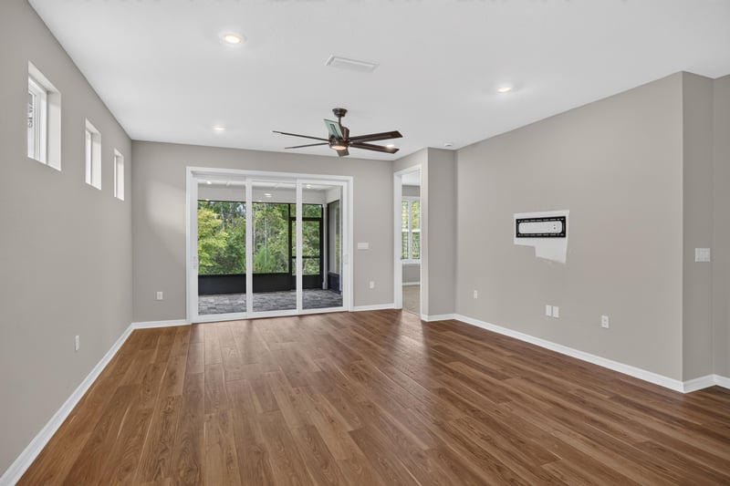 Living room with sliding glass doors and ceiling fan at 171 Oyster Shell Ter, Nocatee, FL 32081