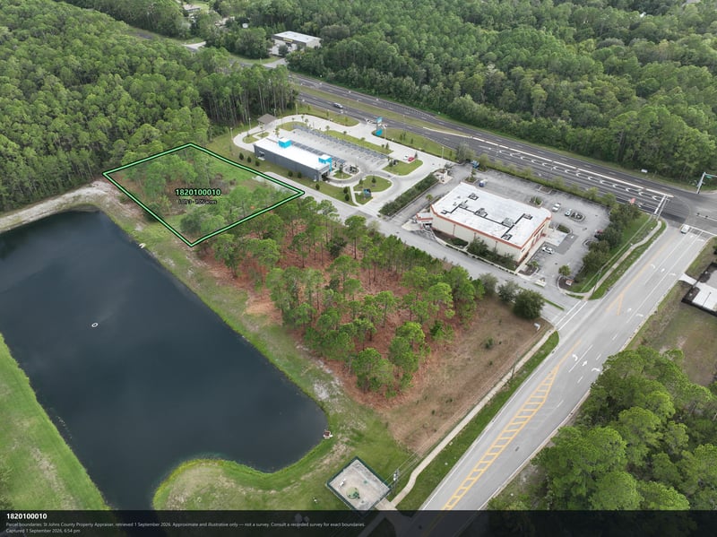 Aerial view of the pond and tree canopy near the building at 4900 US-1, St. Augustine, FL 32086