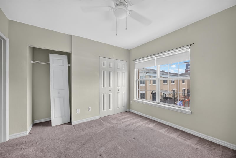 Bedroom with closet doors and window at 342 E Ashley St, Jacksonville, FL 32202
