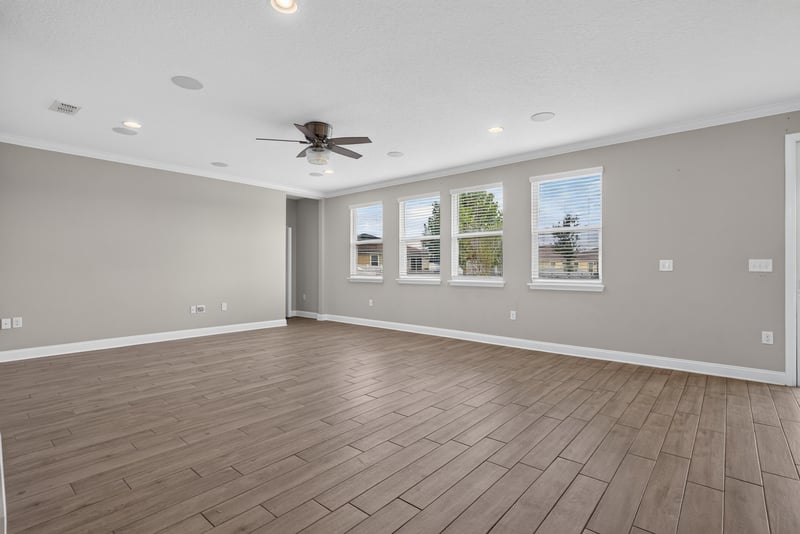 Living room with wood floor and multiple windows at 2580 Cold Stream Ln, Green Cove Springs, FL 32043