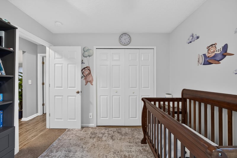 Upstairs hallway with wood railing at 12825 Kelsey Island Dr, Jacksonville, FL 32224