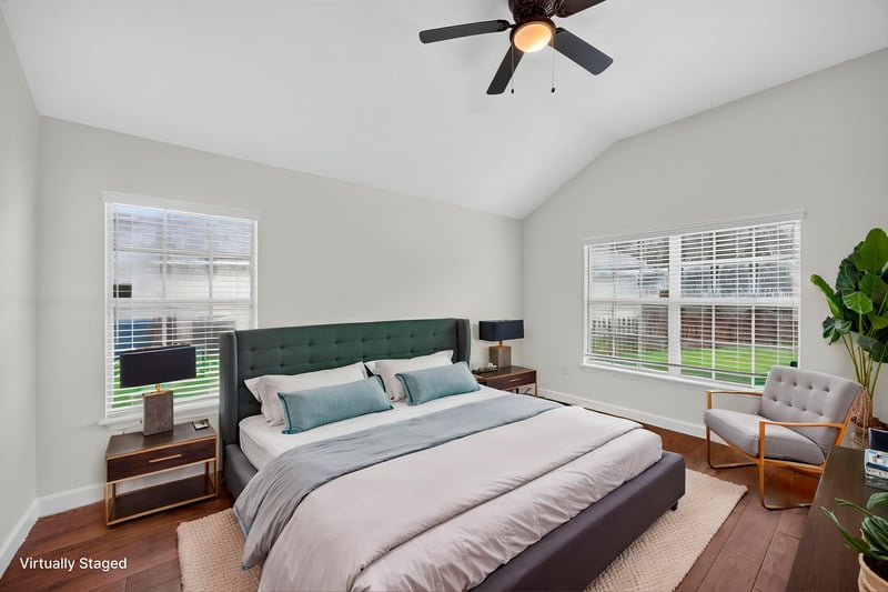 Virtually staged primary bedroom with vaulted ceiling at 706 Bonaparte Dr, Jacksonville, FL 32218