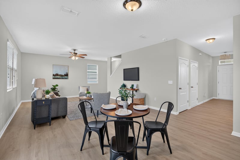 Living room with ceiling fan open to dining area at 6830 Hanford St, Jacksonville, FL 32219