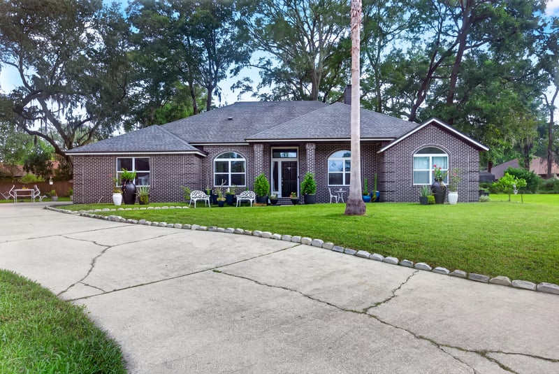 Front exterior with long concrete driveway at 1346 Gately Ct, Jacksonville, FL 32225