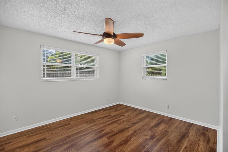 Bedroom with windows, wood floor and ceiling fan at 4039 Habana Ave, Jacksonville, FL