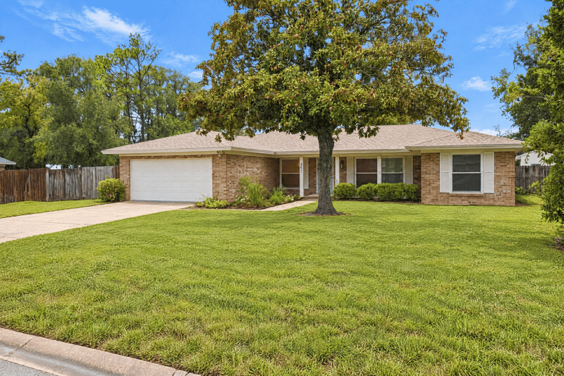 Front exterior with garage and landscaped lawn at 357 Dillon Dr, Orange Park, FL
