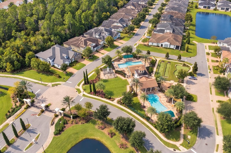 Aerial view of neighborhood with pools and ponds, photographed by Megapixeler on Lucena Ln, Jacksonville, FL