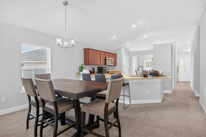 Open dining area with pendant lighting at 9846 Olivia St, Jacksonville, FL