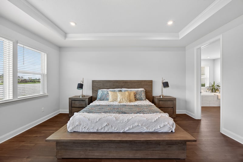 Primary bedroom with wood bed frame at 85491 Fall River Pkwy, Fernandina Beach, FL 32034