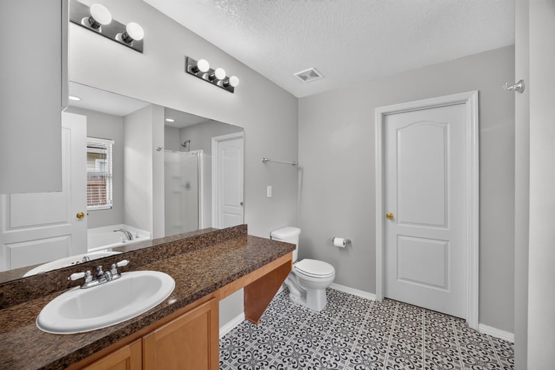 Bathroom with double vanity and granite counter at 7545 Lirope St, Jacksonville, FL 32244