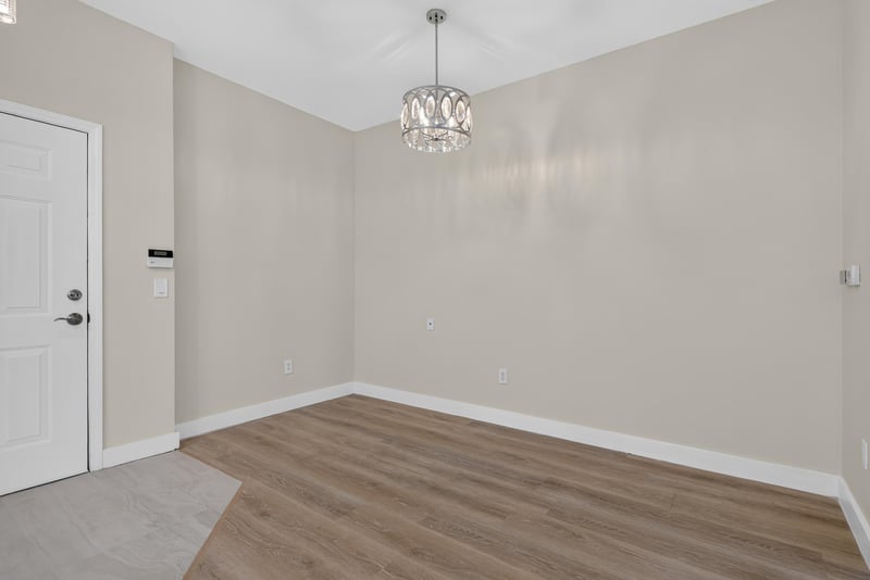 Dining area with chandelier and wood-look flooring at 11251 Campfield Dr unit 1202, Jacksonville, FL 32256