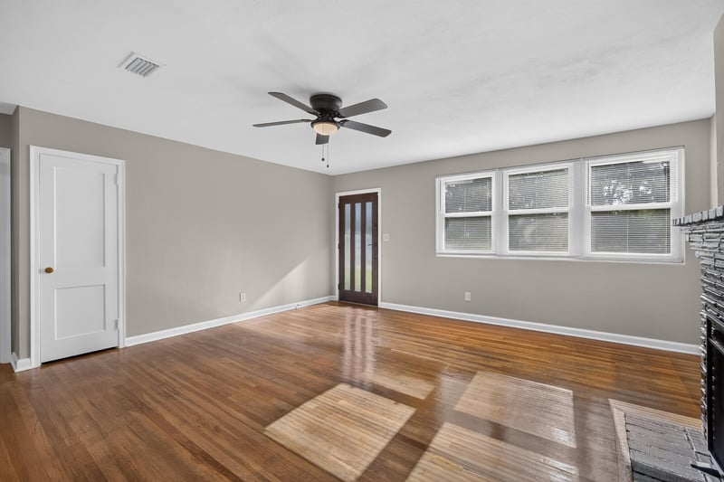 Living room with hardwood floors and double doors at 6338 Mercer Cir W, Jacksonville, FL