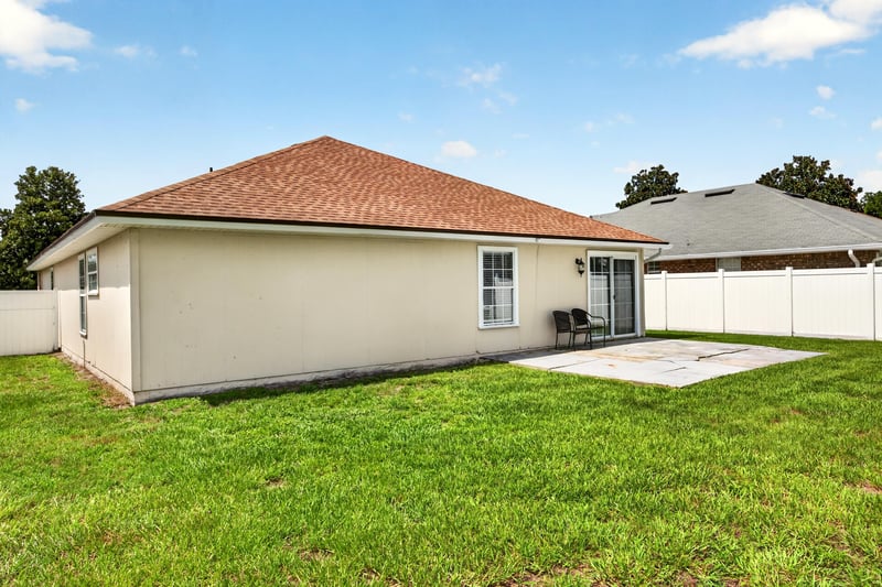 Side rear exterior view with fenced yard at 490 Hillside Dr, Orange Park, FL 32073